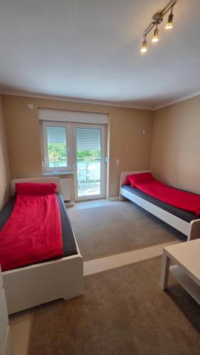 a large room with two beds and a window at 3Raumwohnung mit Balkon in Leipzig Nord BMW, Amazon, Messe & Porsche in Taucha