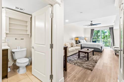 a bathroom with a toilet and a living room at Lasata #3112 in Destin