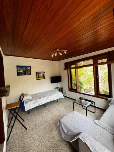 a bedroom with two beds and a wooden ceiling at Casa Colonia in Mogán