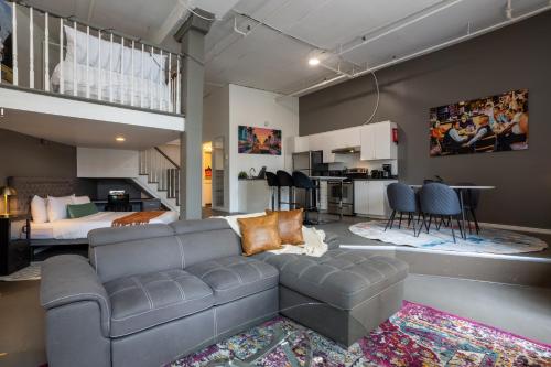 a living room with a couch and a kitchen at 4 Stylish Lofts in Old Montreal in Montréal