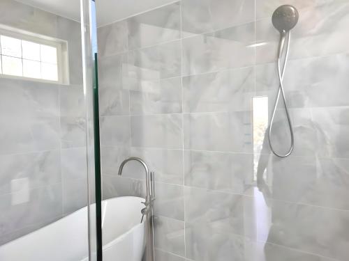 a bathroom with a shower with a shower head at Water Street Retreat in Chelan