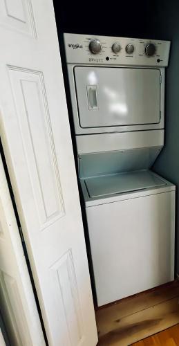 a small white stove in a kitchen next to a door at Water Street Retreat in Chelan