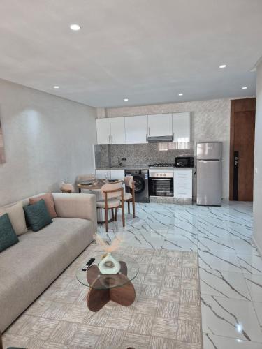 a living room with a couch and a table in it at Holiday Harmony in Roches Noires