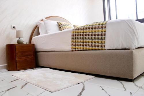 a bedroom with a bed and a table with a rug at Holiday Harmony in Roches Noires