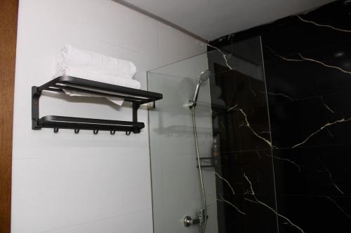 a bathroom with a glass shower stall with towels at Holiday Harmony in Roches Noires