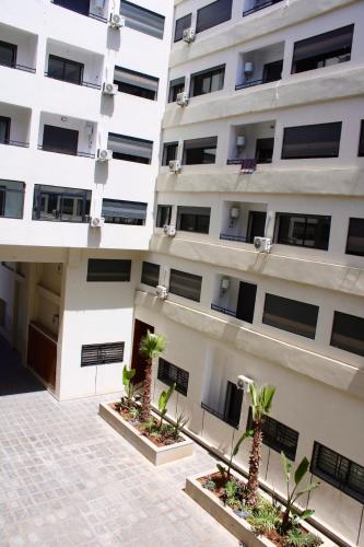 an apartment building with palm trees in the courtyard at Holiday Harmony in Roches Noires