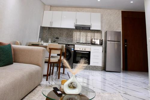 a kitchen with a couch and a table in a room at Holiday Harmony in Roches Noires