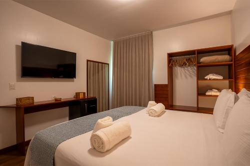 a hotel room with a bed with towels on it at Pousada Lua Bela in Fernando de Noronha