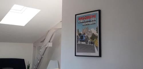 a picture hanging on a wall in a room at Studio de charme entièrement rénové in Linars