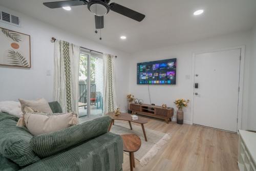 a living room with a couch and a table at Worldcup Ready DT DFW Chic Free Parking and Pool In Medical District in Dallas