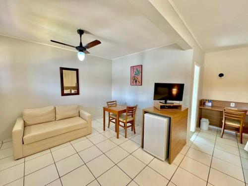 a living room with a couch and a table at Hotel Recanto dos Pássaros in São Sebastião