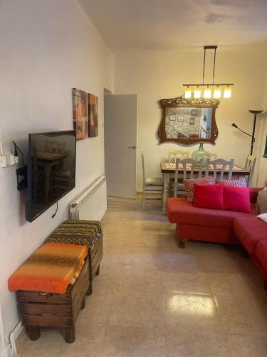 a living room with a red couch and a table at Casa rural muy acogedora in Contreras