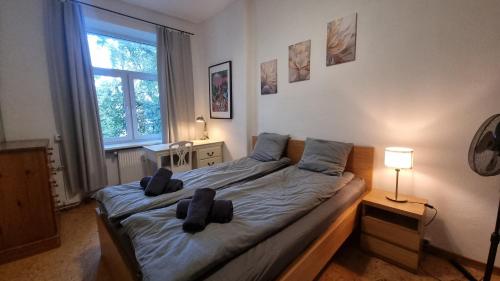 a bedroom with a bed with two pillows on it at City center, High ceilings, 75m2 2BR Free parking in Tallinn