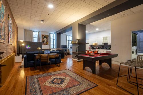 a living room with a ping pong table in it at 4 Stylish Lofts in Old Montreal in Montréal