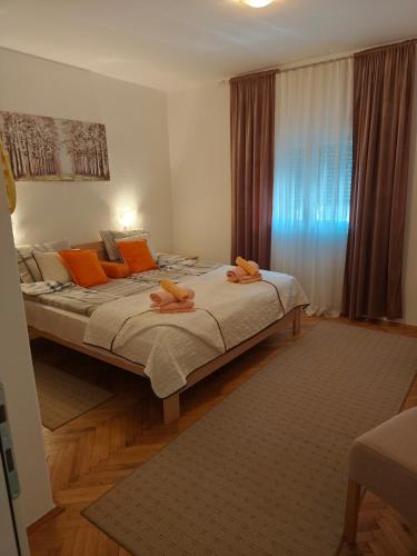 a bedroom with a bed with two towels on it at Kuća JEKA in Vrnjačka Banja