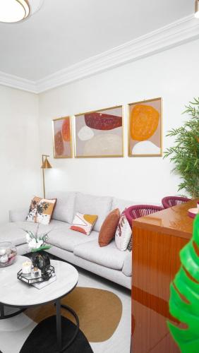 a living room with a couch and a table at Tériya House in Dakar