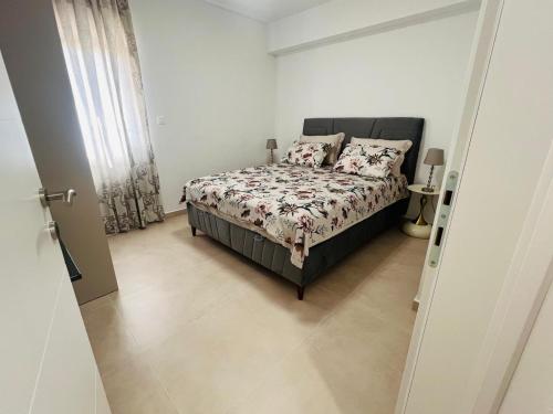 a bedroom with a bed with a comforter and pillows at Apartmani Leon in Međugorje