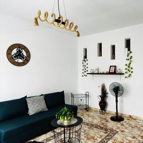 a living room with a green couch and a table at Apartamento Mia Gran Tarajal in Gran Tarajal