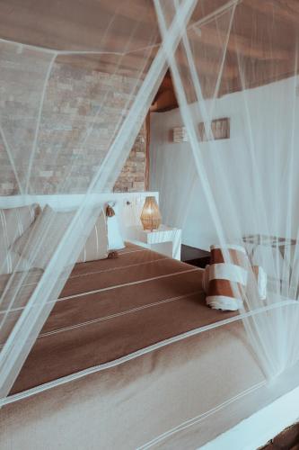 a bedroom with a bed with a net at Niken Beachfront Tulum Hotel in Tulum