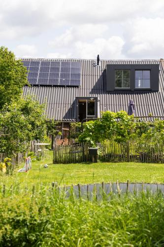 a house with solar panels on the roof at B&B Maas en Heuvel Maastricht in Maastricht
