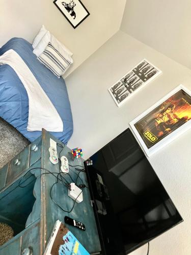 a bedroom with a bed and a flat screen tv at The Texas Bluebonnet Home in Historic McKinney in McKinney