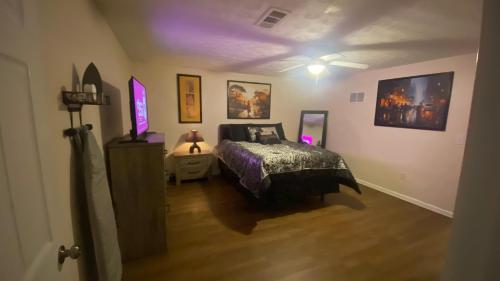 a bedroom with a bed and a ceiling fan at Your Private 1-Bedroom Guest House in College Park in College Park