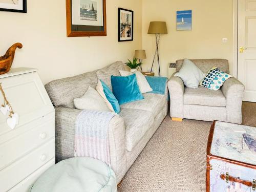 a living room with a couch and a chair at Hydan Creek Gardens in Wootton Bridge