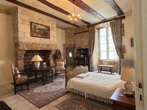 una camera da letto con un letto e un camino di 16th Century Manoir du Belvedere - central, unique, historical, with all modern amenities ad Auray