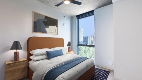 a bedroom with a bed and a large window at Sentral Sol Modern in Phoenix