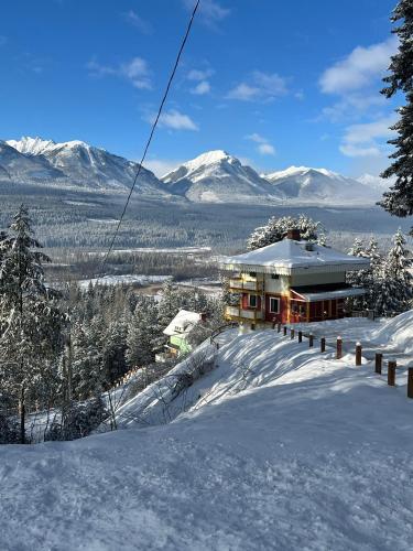 a house on top of a snow covered mountain at Edelweiss Village & Resort – Chalet Aemmer in Golden