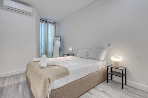 Postel nebo postele na pokoji v ubytování OPORTO GUEST Marquês Square