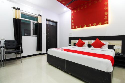 a bedroom with a large bed with red pillows at Taj 3 Star Hotel Agra Near Taj Mahal in Tājganj