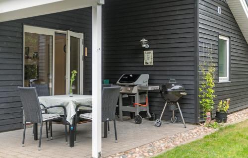 a patio with a table and chairs and a grill at Lovely Home In Ansager With Wifi in Ansager