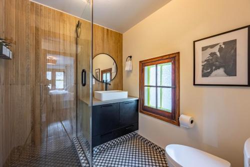 a bathroom with a shower and a sink and a toilet at Chalet Haesler Sr - Edelweiss Village in Golden