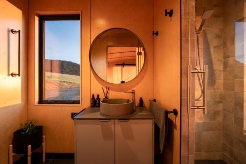 a bathroom with a sink and a mirror at Beresford Heights & Rise in Maclennan