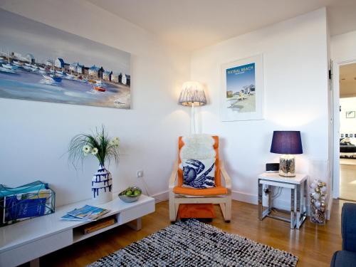 a living room with a chair and a table at 42 Ocean 1 in Crantock