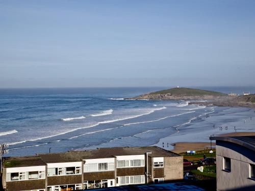 a view of a beach with buildings and the ocean at 42 Ocean 1 in Crantock