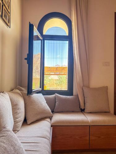 a couch sitting in front of a window at Dar Katrine in Saint Catherine