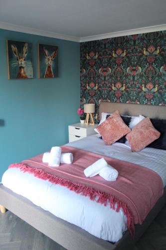 a bedroom with a large bed with a red blanket at Thorpe Park Studio - Detached Stay & Free Gated Parking in Thorpe