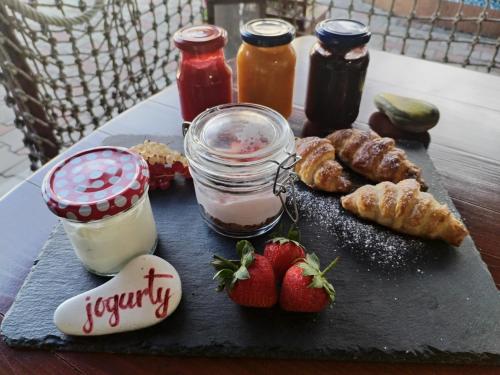 a tray of food with strawberries and pastries on a table at Slovácká maringotka in Šumice