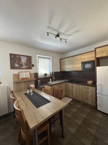 a kitchen with a wooden table and a refrigerator at Privat vila 303 in Martin