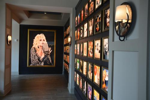 a hallway with a bunch of pictures on the wall at Dollywood's DreamMore Resort and Spa in Pigeon Forge