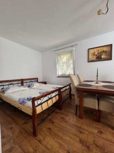 a bedroom with a bed and a table and a dining room at Privat vila 303 in Martin