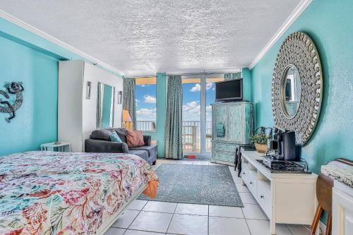 a bedroom with a bed and a television in a room at Seagull's Nest in Daytona Beach