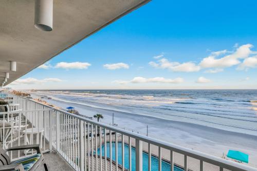 a view of the beach from the balcony of a beach house at Seagull's Nest in Daytona Beach
