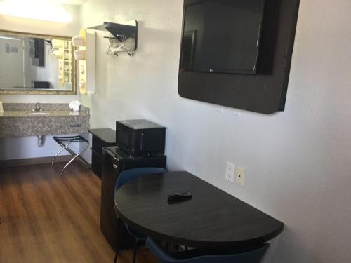 a room with a table and a television on the wall at Motel 6-El Paso, TX - West in El Paso