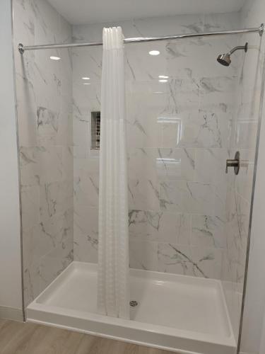 a bathroom with a shower with a shower curtain at Casa Blanca Inn and Suites in Chandler