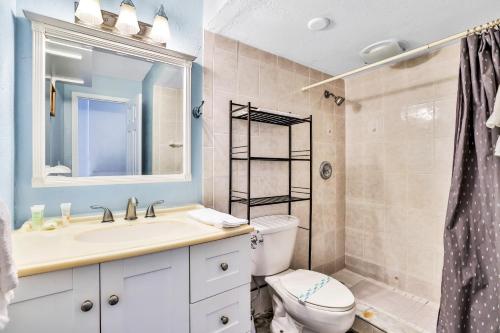 a bathroom with a sink and a toilet and a mirror at Atlantic Skies in Daytona Beach Shores