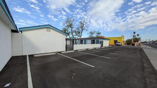 a parking lot with a building and a parking lot at Casa Blanca Inn and Suites in Chandler