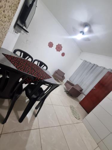 a dining room table and chairs in a room at Casa Atenas 2 in Três Lagoas